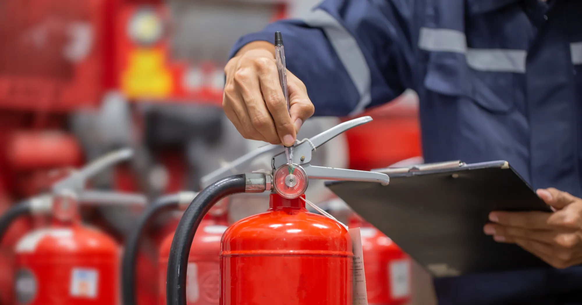 Technician inspecting a fire extinguisher